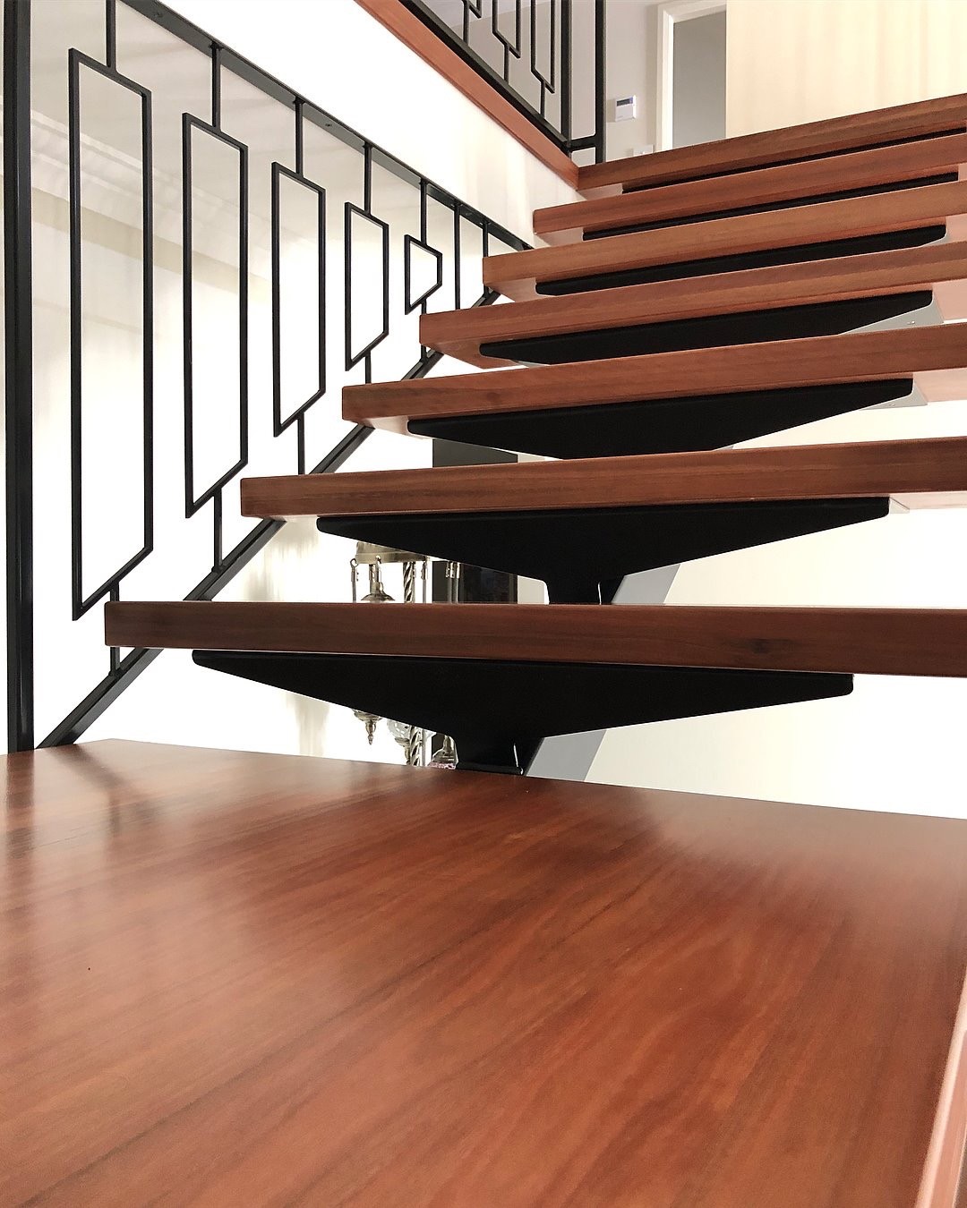 Designer Staircase Monostringer steel spine staircase with solid Australian Hardwood tread, metal Baluster and Hardwood handmade handrail supplied and installed by Timber Floors Pty Ltd