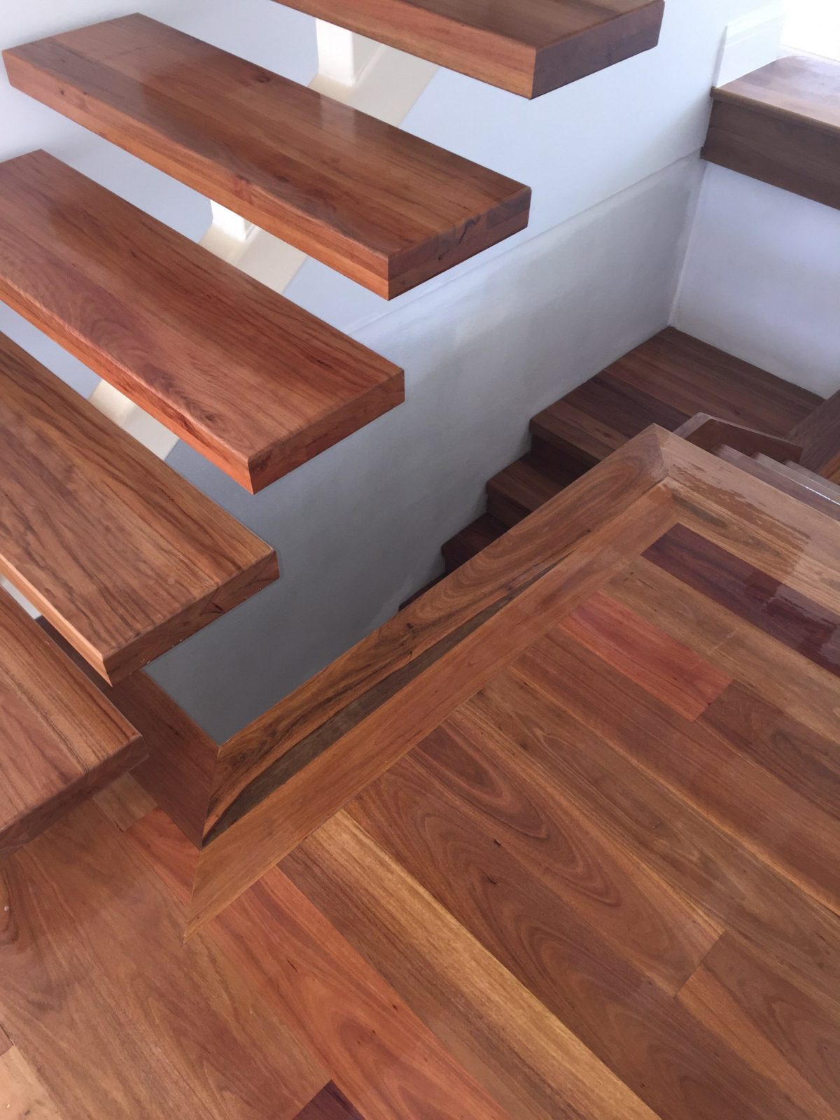 Spotted Gum timber flooring and solid staircase treads with steel spine by Timber Floors Pty Ltd