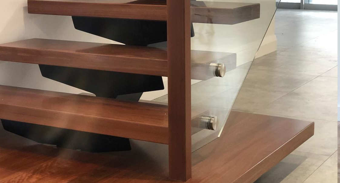 Glass baluster with steel spine staircase and solid timber treads by Timber Floors Pty Ltd